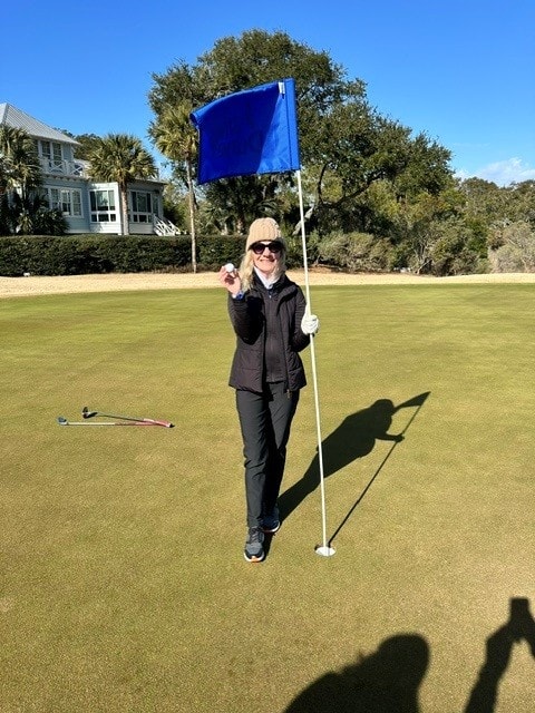 Adele Nielsen celebrating her hole-in-one at Wild Dunes Links Hole 4