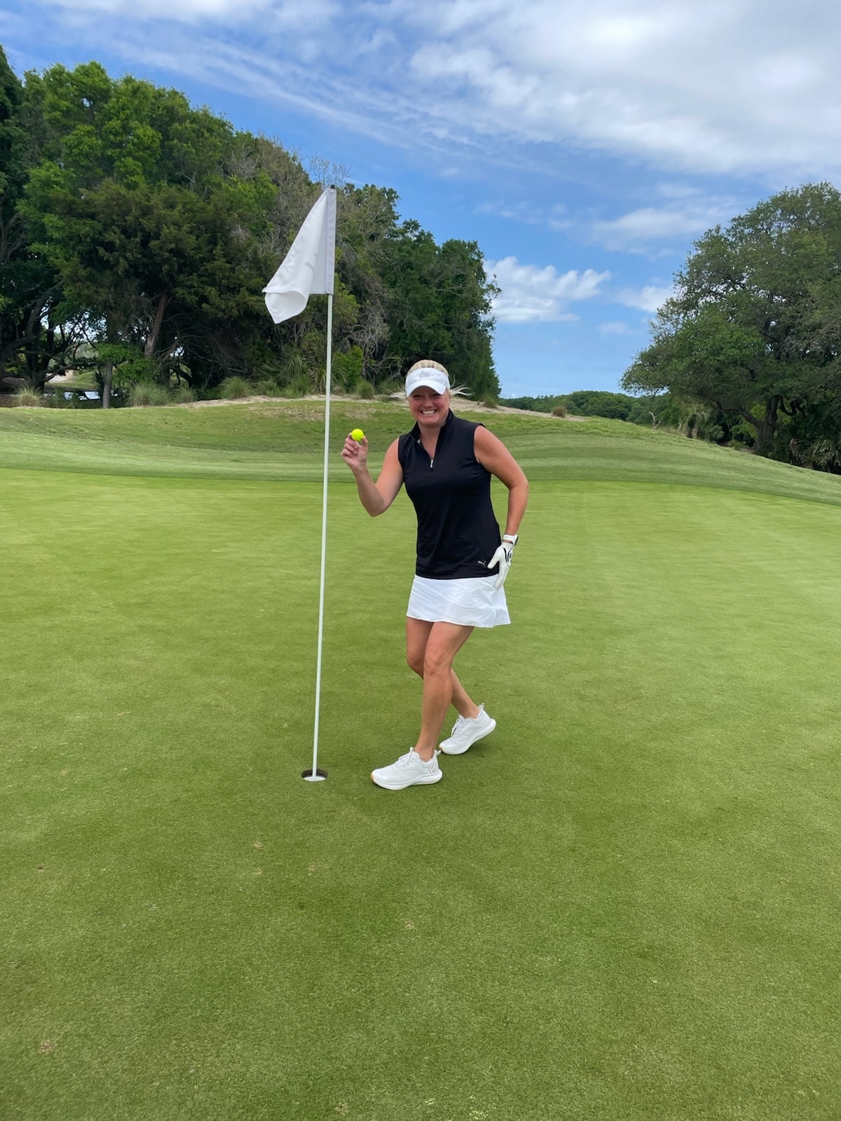 Becky Seurkamp celebrating her hole-in-one at Wild Dunes Links Hole 12