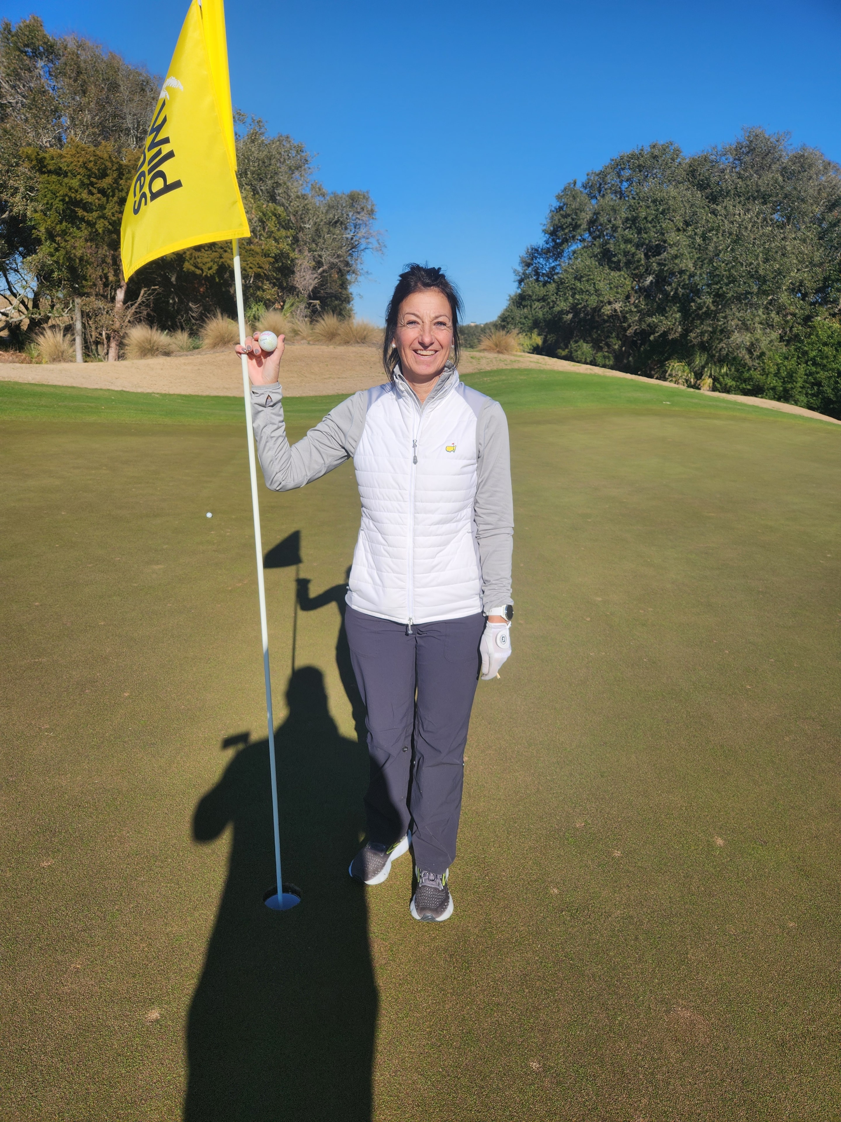 Linda Muzzy celebrating her hole-in-one at Wild Dunes