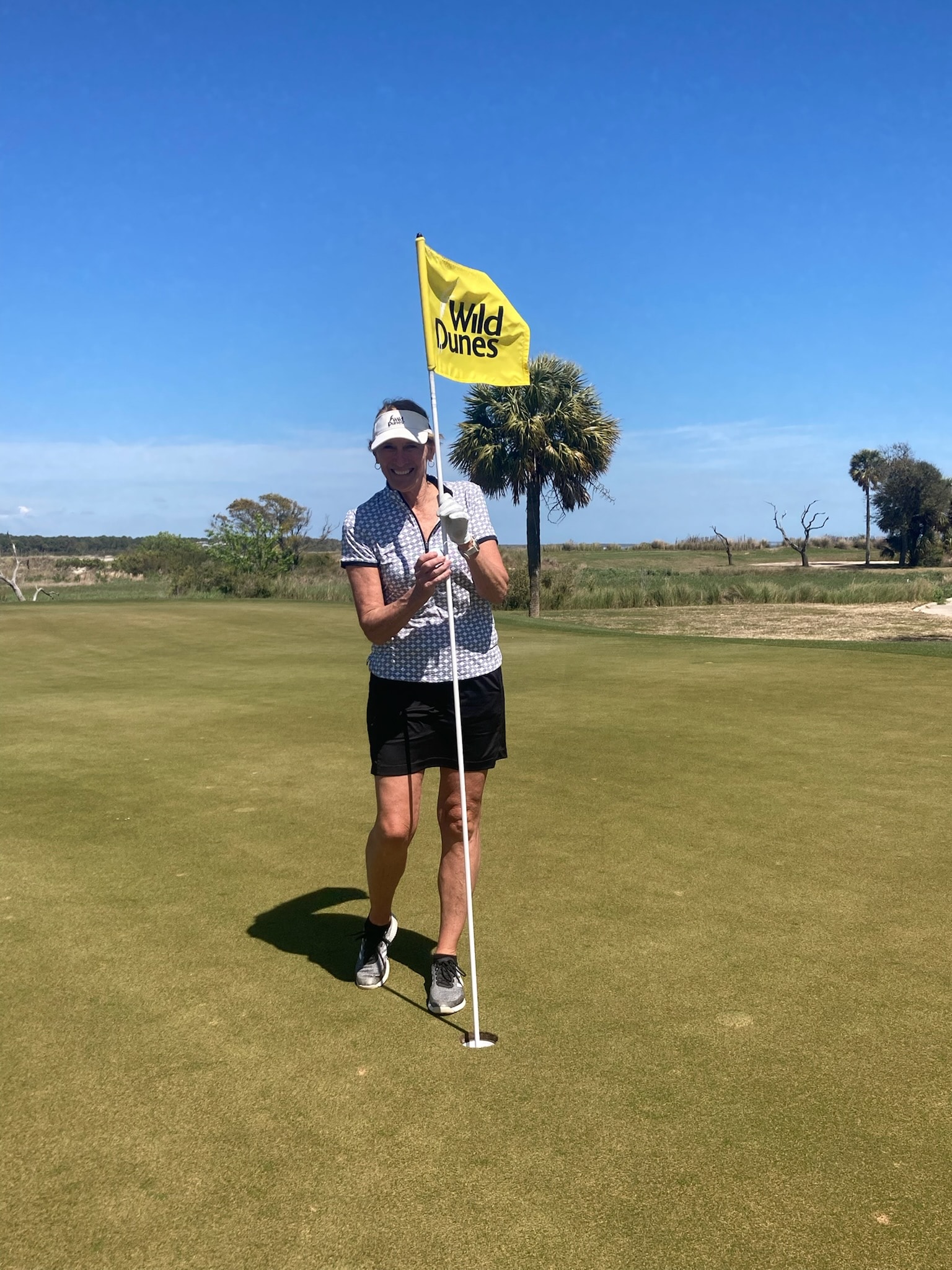 Robin Smith celebrating her hole-in-one at Wild Dunes Links Hole 16