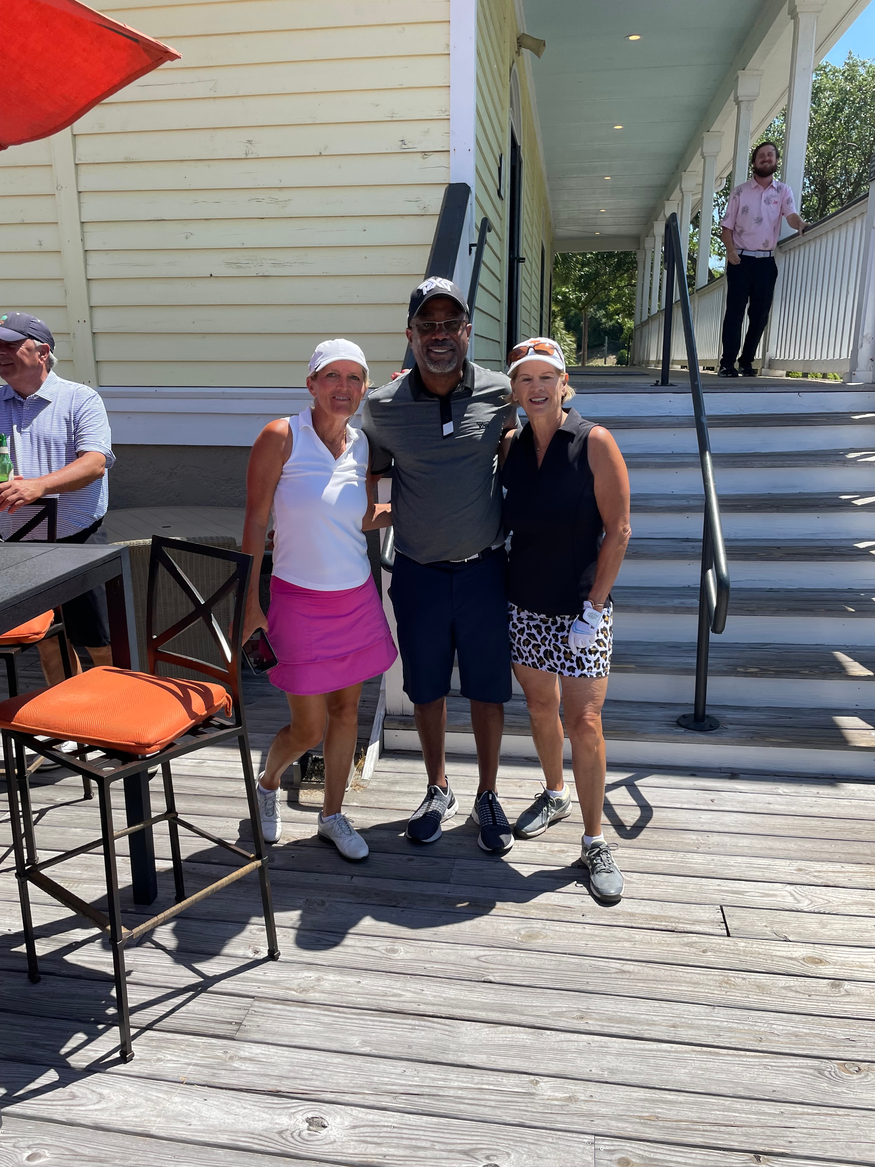 Wild Dunes members posing together on the deck after a round