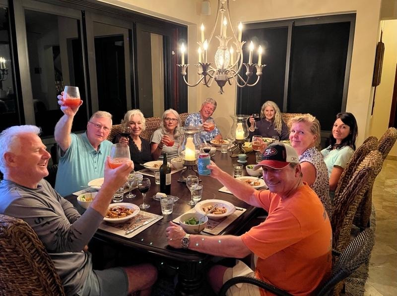 Wild Dunes members raising a toast at a group dinner
