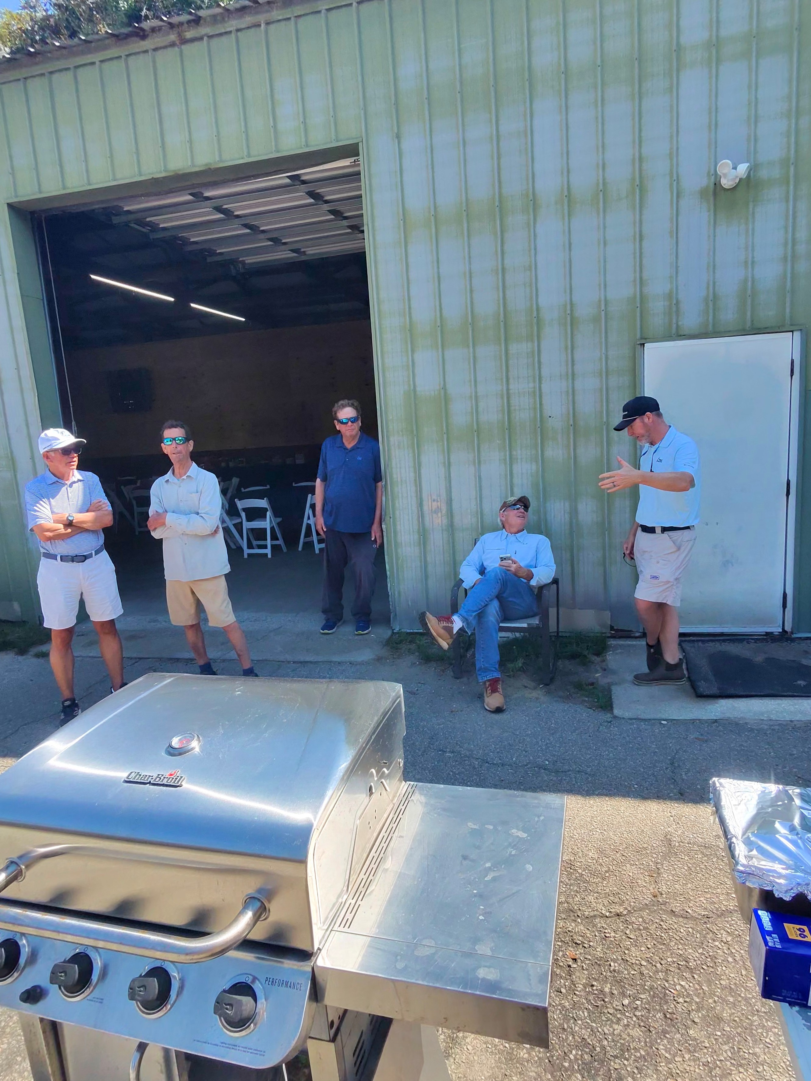 Five Wild Dunes members gathered around the grill before the appreciation lunch