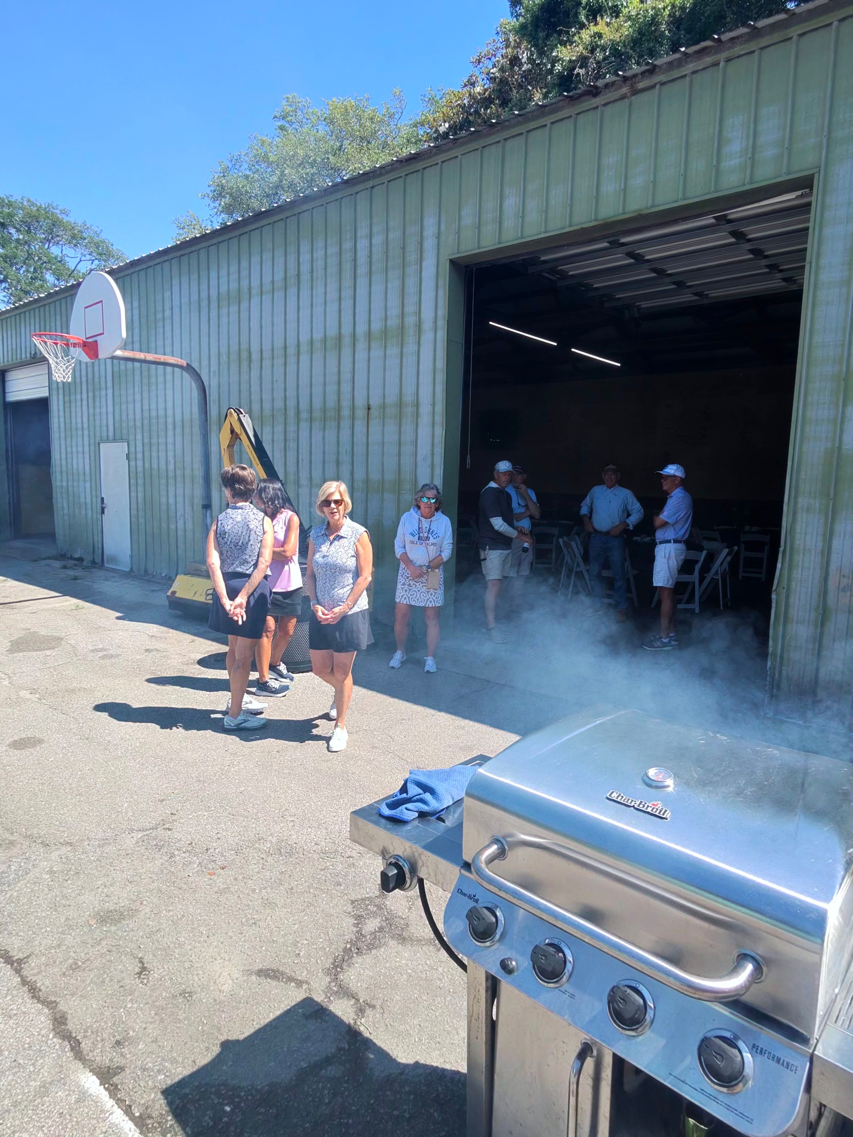 Char-Broil grill fired up with members gathering outside the maintenance barn for the appreciation lunch