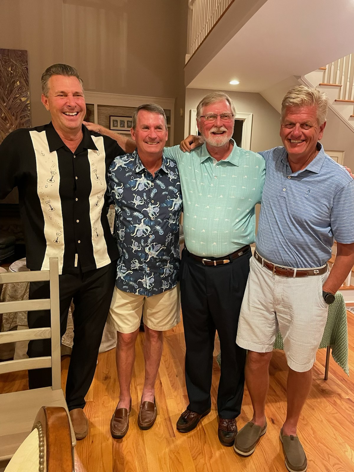 Four Wild Dunes members laughing together at a club social event