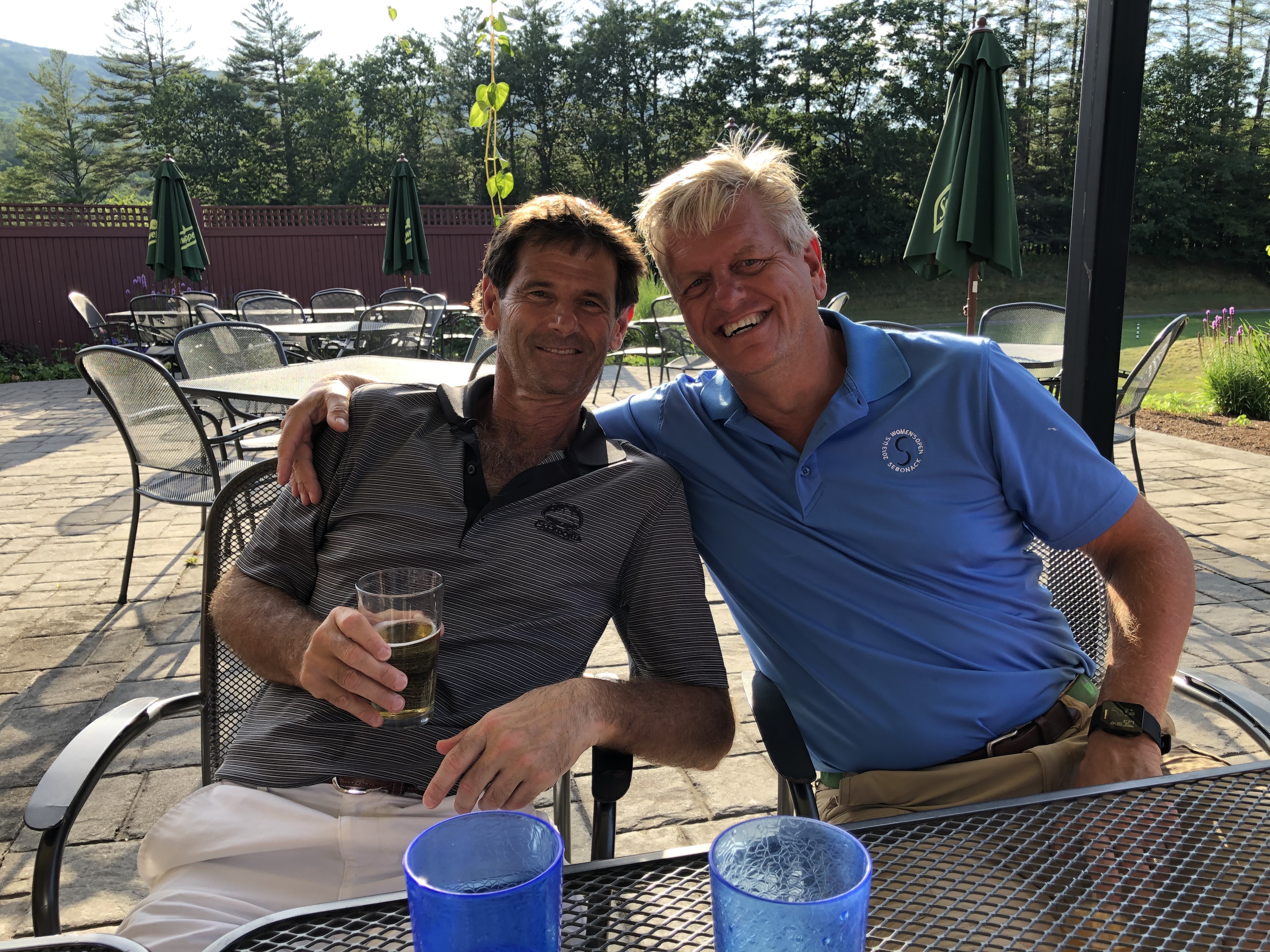Two Wild Dunes club members enjoying drinks on the patio after a round